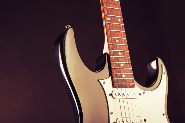 Closeup of modern electric guitar. Toned image