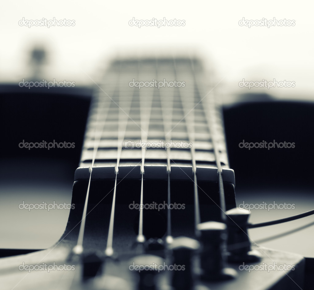 Closeup of electric guitar fretboard with strings Stock Photo by