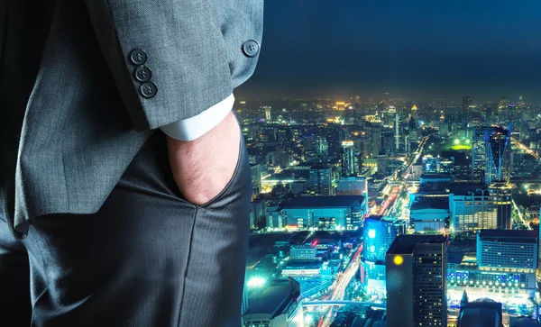 Businessman staying against night downtown — Stock Photo, Image