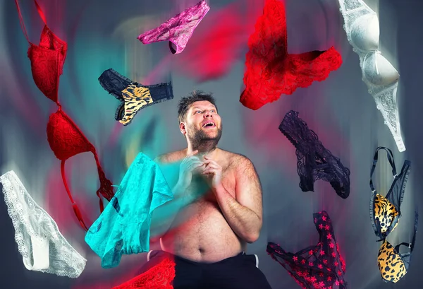 Man looking at flying womans underwear — Stock Photo, Image