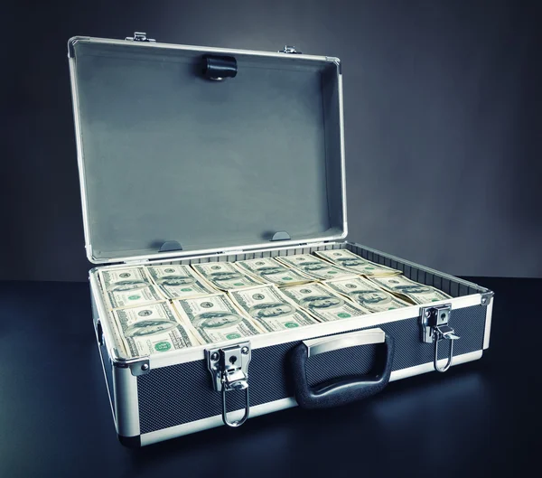 Case full of money on gray background — Stock Photo, Image