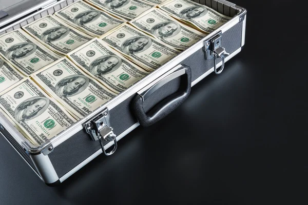 Case full of money on gray background — Stock Photo, Image