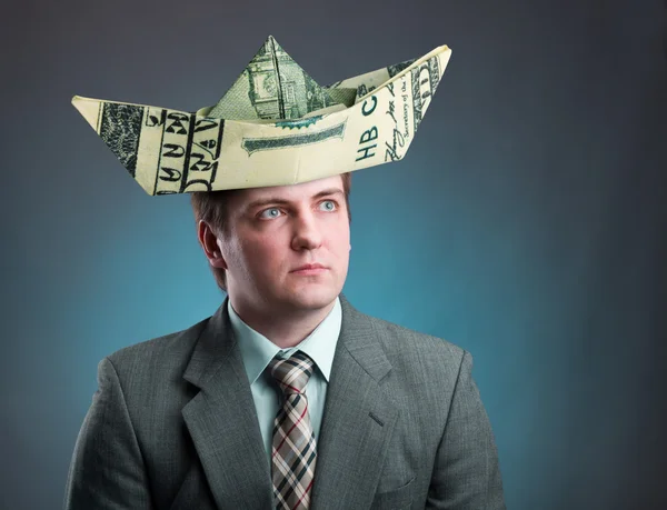 Businessman with hat of ship from a money — Stock Photo, Image