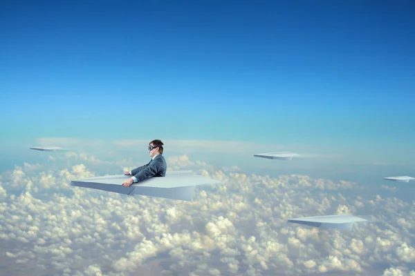 Businessman flying on paper plane — Stock Photo, Image