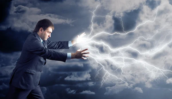 Young man with lightnings from his hands — Stock Photo, Image