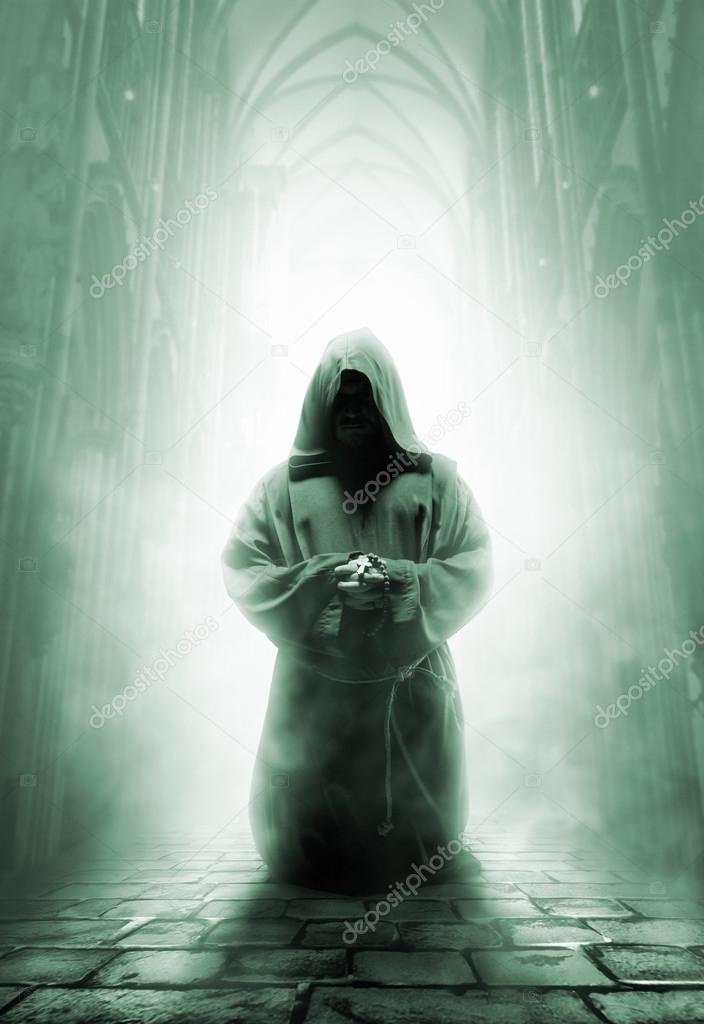 Praying medieval monk in dark temple corridor