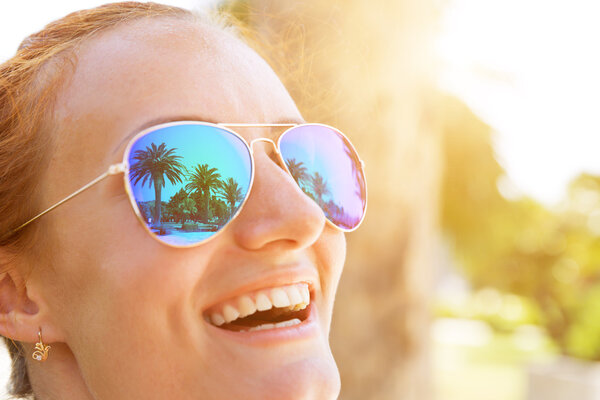 Palm trees reflect in  sunglasses