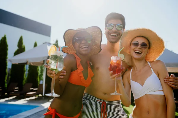 Freunde mit Coctails posieren am Pool im Hotel — Stockfoto