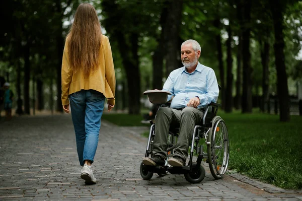 Adult disabled man in wheelchair asks for alms — Stock Photo, Image