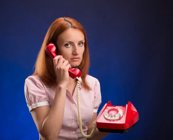 Redhead woman with red telephone — Stock Photo, Image