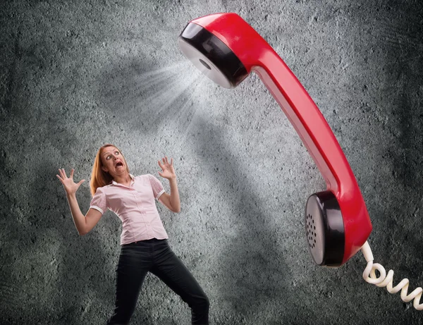 El teléfono está gritando a la mujer asustada — Foto de Stock