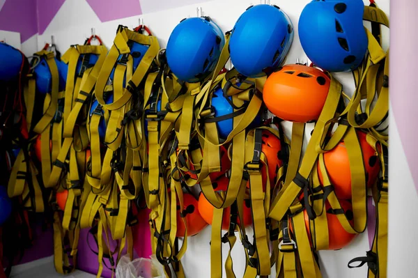 Helmets and climbing equipment hanging on the wall — Stock Photo, Image