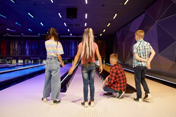 Children throw a ball on the lane in bowling alley — Stock Photo, Image