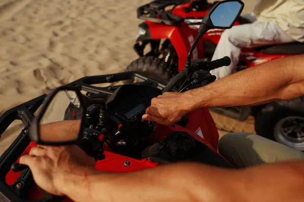 Man rides on atv in desert, closeup view on hands — Stock Photo, Image