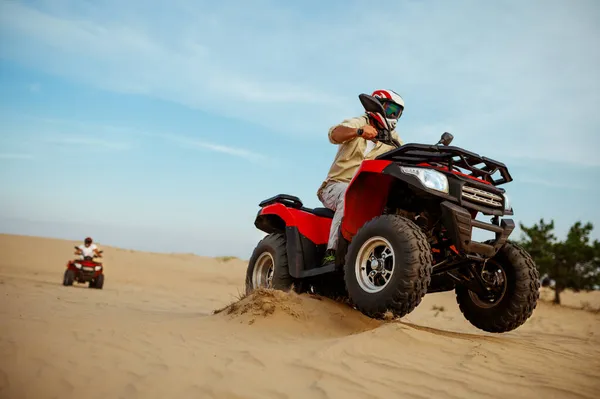 Two men in helmets ride on atv, action view — Stock Photo, Image