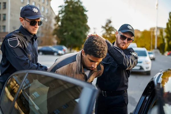 Two male police officers arrest young man — Stock Photo, Image