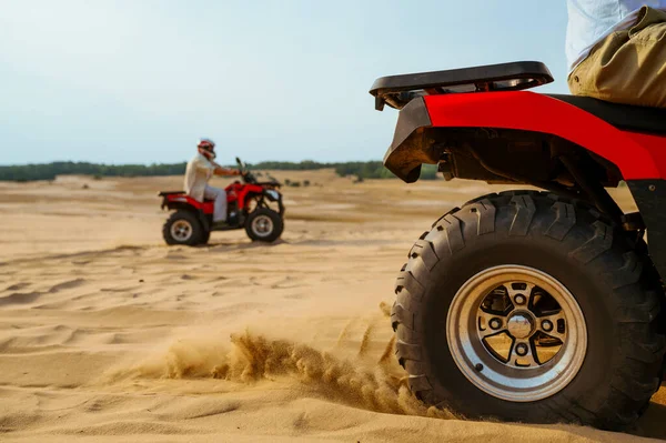 View on atv wheel, man in helmet on background — Stock Photo, Image