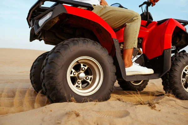 Man in helmet rides on atv in desert, action view — Stock Photo, Image