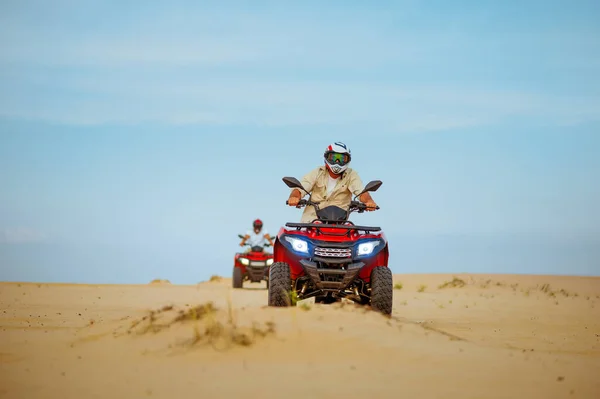 Two men in helmets ride on atv, action view — Stock Photo, Image