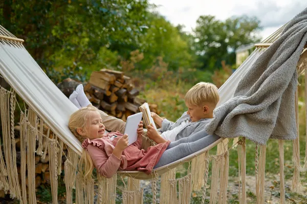 Funny kids lying in a hammock, summer camping — Stock Photo, Image