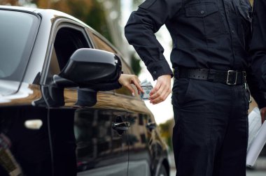 Polis memuru kadın bir şoförden rüşvet alıyor.