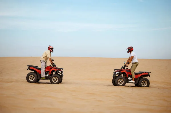 Two racers in helmets stand face to face on atvs — Stock Photo, Image