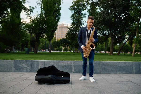 Férfi szaxofonos játszik dallam a parkban, tehetség — Stock Fotó