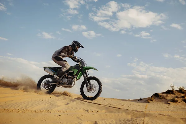 Professional motocross rider sliding down sand hill — Stock Photo, Image