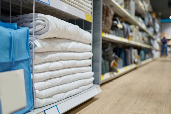 Blanket stacked on shop shelves selective focus — стоковое фото