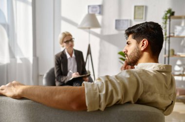 Frustrated pensive sad man at psychotherapist consultation