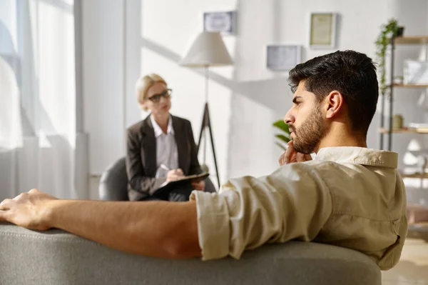 Frustrated pensive sad man at psychotherapist consultation — Stock Photo, Image