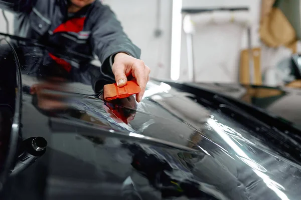 Auto service worker coating luxury black car — Stok fotoğraf