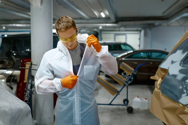 Technician unzipping protective suit after finishing work — Stok fotoğraf