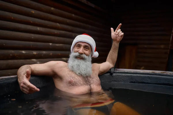 Santa Claus resting in bath vat outside — Stockfoto