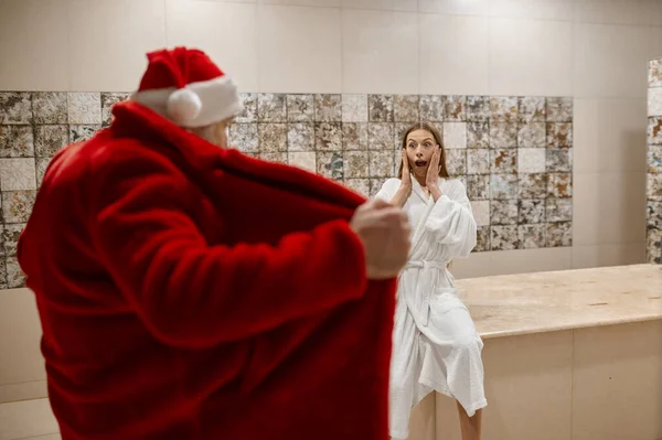 Bad Santa scared woman with open bathrobe — 图库照片
