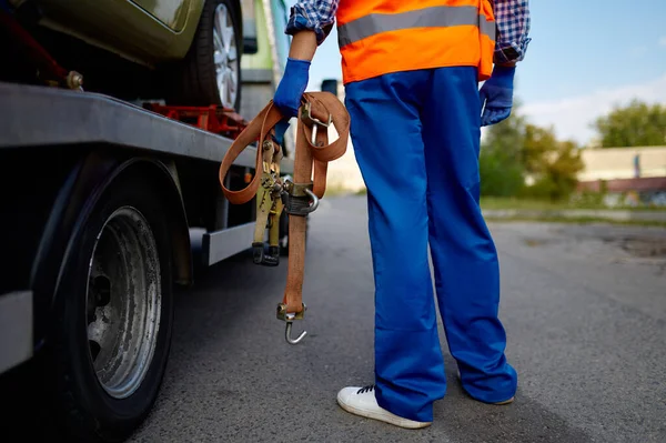 Male tow truck assistant holding fastening belts — Stock Photo, Image