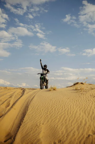 Motorcross rider with raised hand front view — Stock Photo, Image