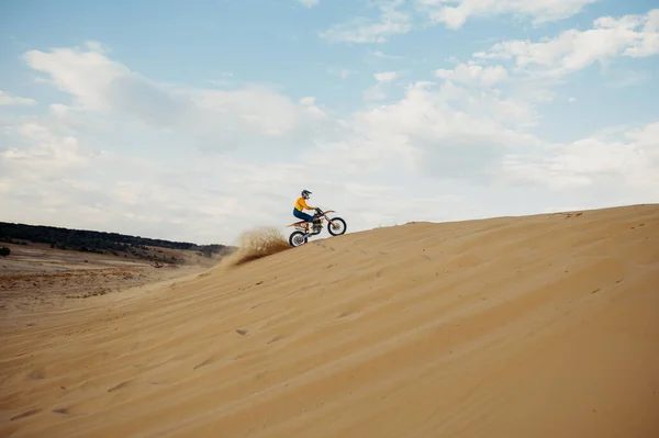 Motorcross riding over sand in desert dune — Stock Photo, Image