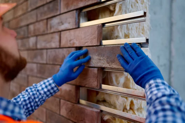 Worker cladding stone for external wall warming — Stock Photo, Image