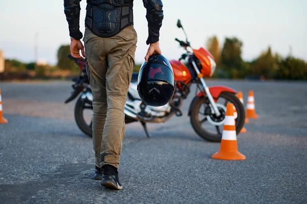 Male person holds helmet, motorcycle school — Stock Photo, Image