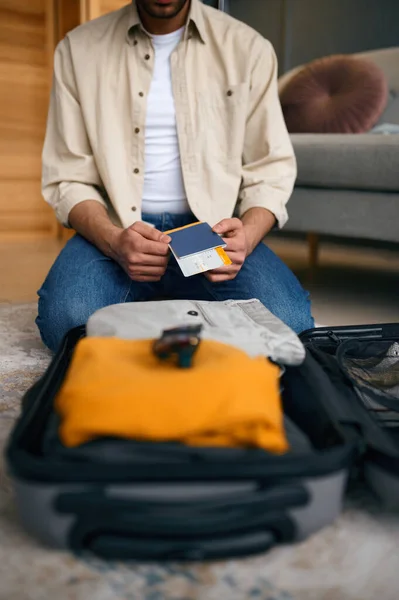 Closeup of travel ticket in male hands — Stock Photo, Image