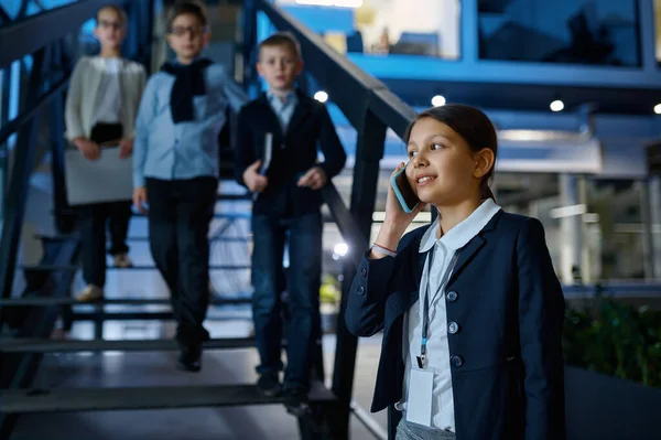 Business children at hall of office building — Stock Photo, Image
