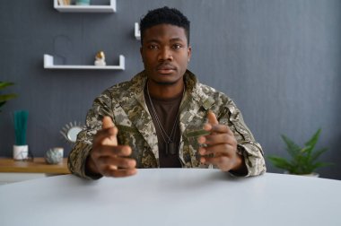 Askeri adam kamera portresine bakıyor.