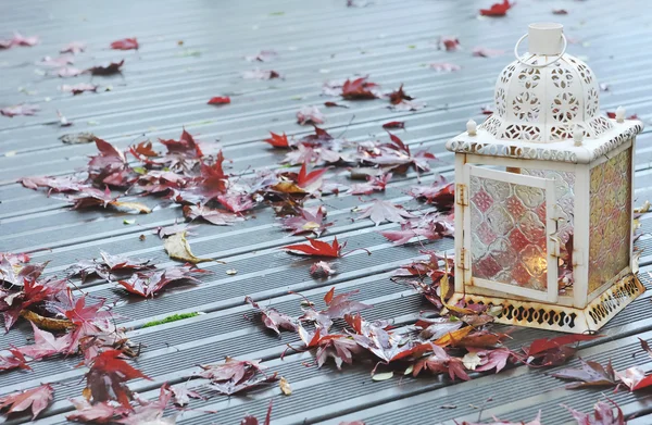 Lantern on a wet wooden deck — Stock Photo, Image