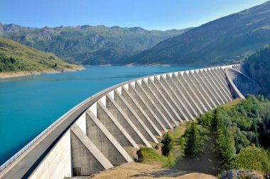 the roselend dam with turquoise water in a mountainous landscape in France