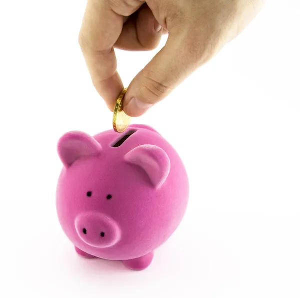 Piggy bank rosa e mão com moeda — Fotografia de Stock