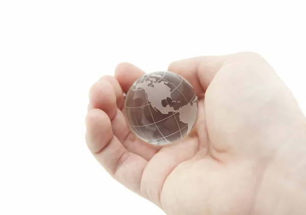 Crystal globe in de hand met uitknippad — Stockfoto