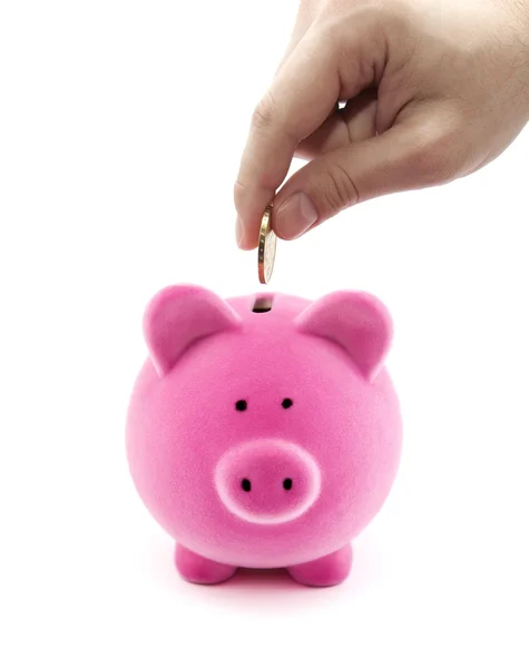 Putting coin into the piggy bank — Stock Photo, Image