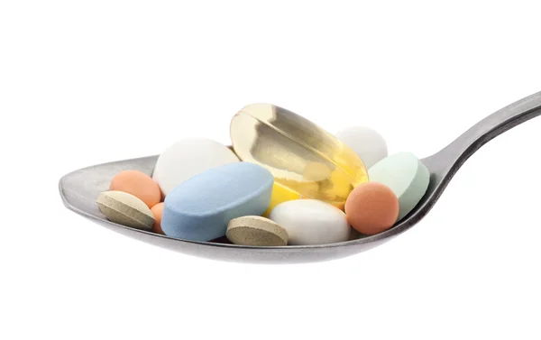 Pills on spoon with clipping path — Stock Photo, Image