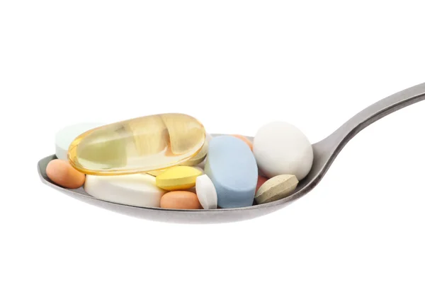 Pills on spoon with clipping path — Stock Photo, Image